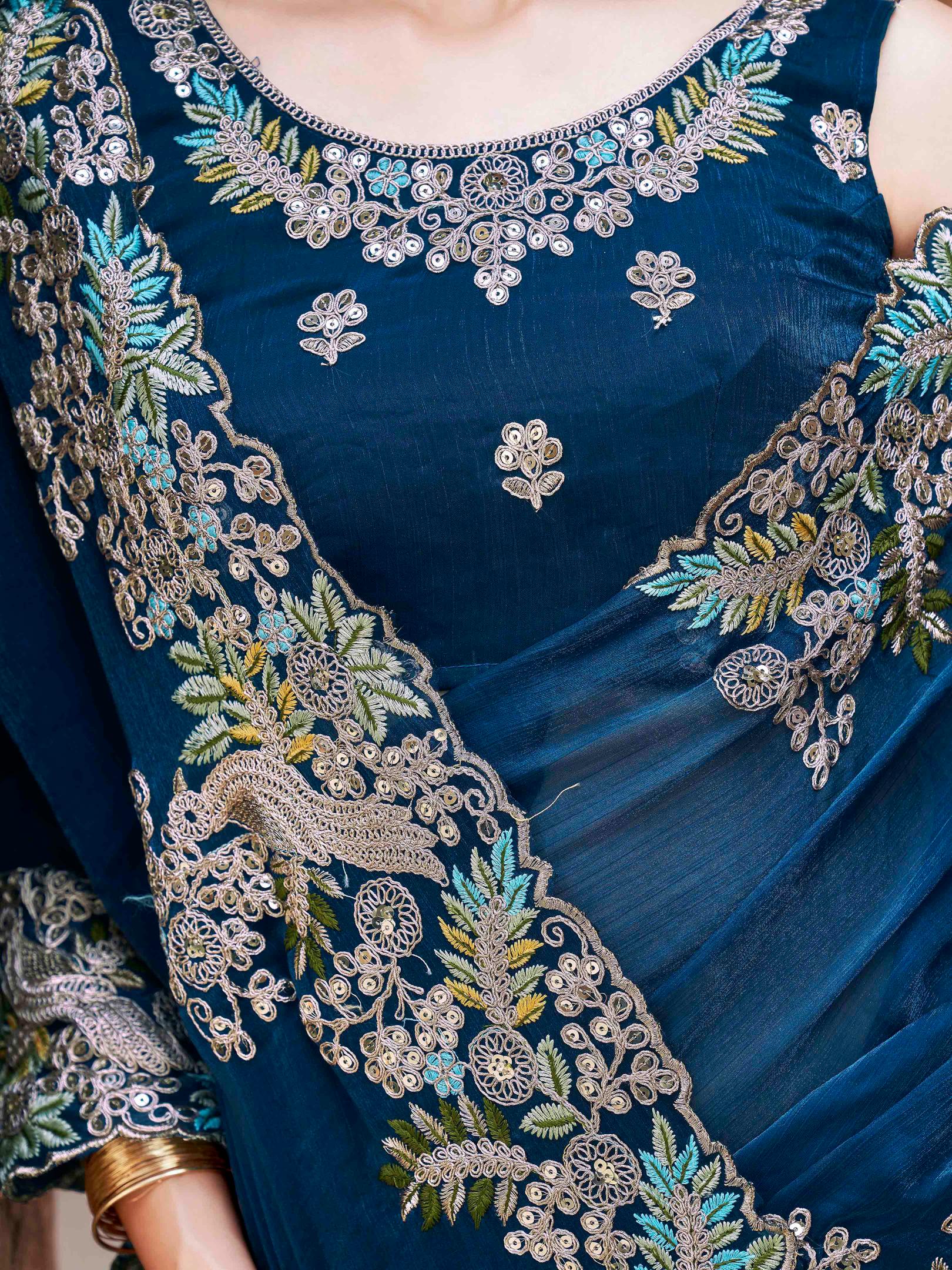 teal colored designer jimmy choo saree with sequinned embroidery border